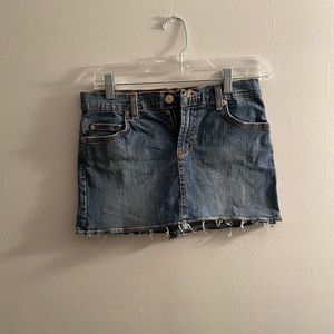 Distressed denim mini skirt.